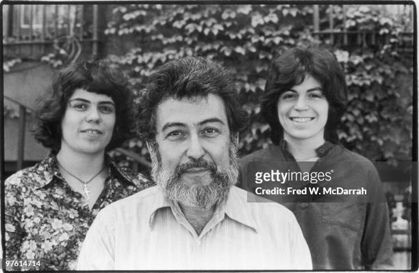 Portrait of American journalist and music critic Nat Hentoff as he poses with his daughters Miranda and Jessica, New York, New York, May 31, 1977.