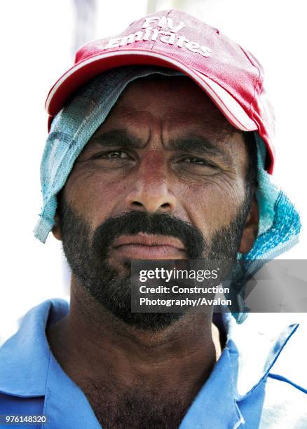 Abdul Khaliq, a construction worker, talks with an ITP reporter on Sheikh Zayed road, Dubai, United Arab Emirates, July 3, 2005.