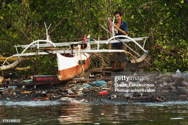 Indonesia, North Sulawesi, near Bitung, Lembeh Strait, Jukung, pollution on the beach.