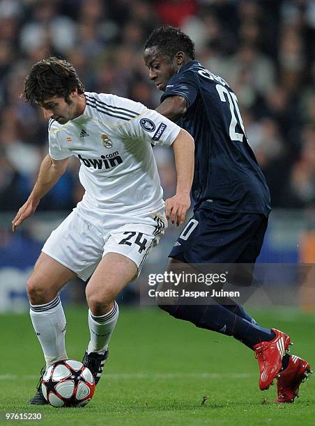Aly Cissokho of Lyon duels for the ball with Esteban Granero of Real Madrid during the UEFA Champions League round of 16 second leg match between...