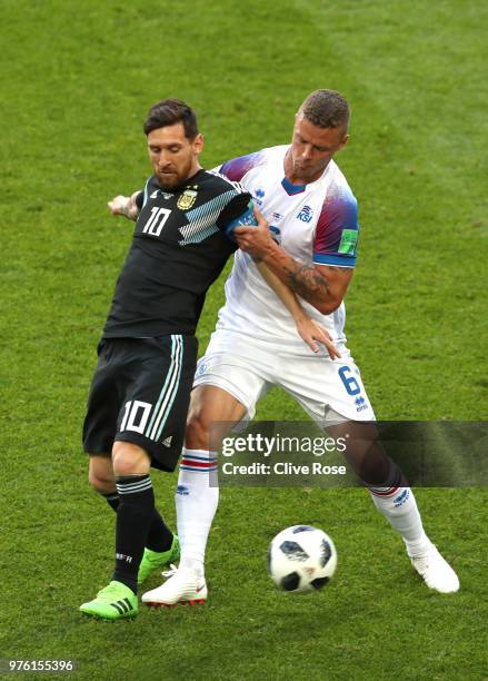 Lionel Messi of Argentina is challenged by Ragnar Sigurdsson of Iceland during the 2018 FIFA World Cup Russia group D match between Argentina and...