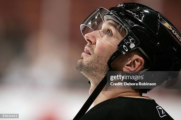 Aaron Ward of the Anaheim Ducks looks up at the jumborton from the ice during warm ups prior to the game against the Columbus Blue Jackets on March...