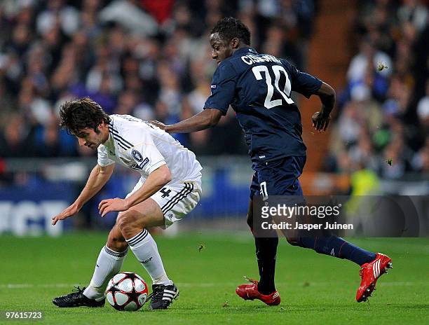 Aly Cissokho of Lyon battles for the ball with Esteban Granero of Real Madrid during the UEFA Champions League round of 16 second leg match between...