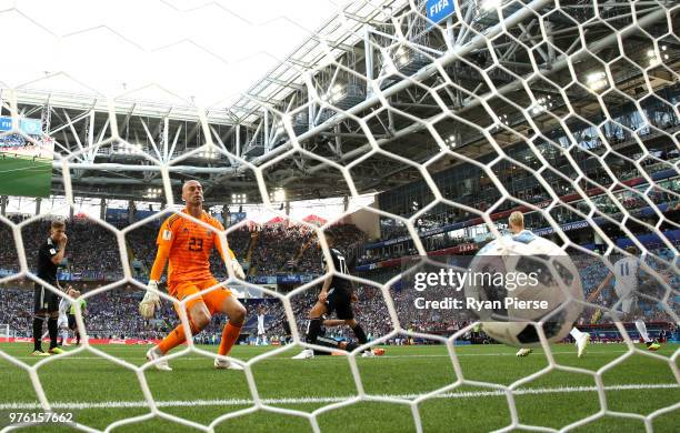 Wilfredo Caballero of Argentina looks dejected as Alfred Finnbogason of Iceland celebrates after scoring his team's first goal during the 2018 FIFA...