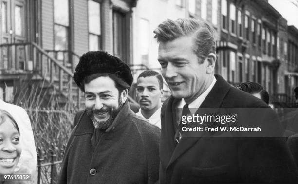 American politician and Mayor of New York John V. Lindsay walks with journalist and music critic Nat Hentoff during an inspection of Brooklyn streets...