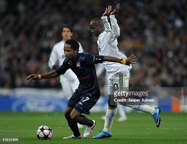 Jean II Makoun of Lyon duels for the ball with Lassana Diarra of Real Madrid during the UEFA Champions League round of 16 second leg match between...
