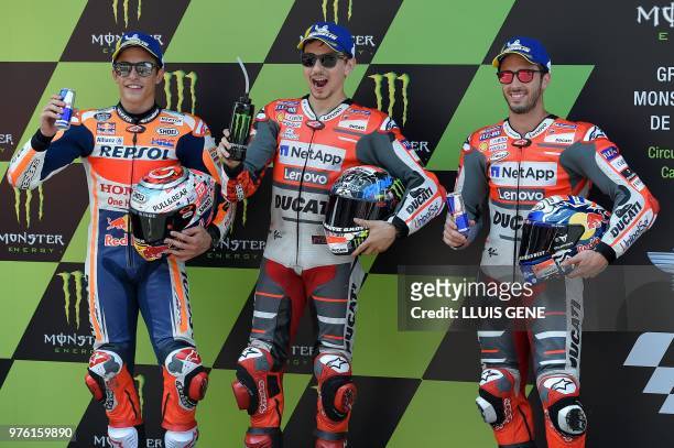 Ducati Team's Spanish rider Jorge Lorenzo , Repsol Honda's Spanish rider Marc Marquez and Ducati Team's Italian rider Andrea Dovizioso pose after the...