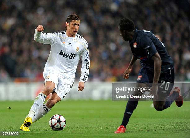 Cristiano Ronaldo of Real Madrid is challenged by Aly Cissokho of Olympique Lyonnais during the UEFA Champions League round of 16 2nd leg match...