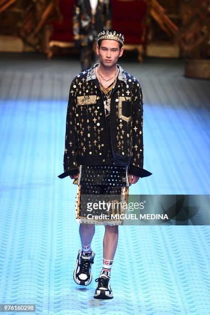Model presents a creation by Dolce & Gabbana during the men's & women spring/summer 2019 collection fashion show in Milan, on June 16, 2018.