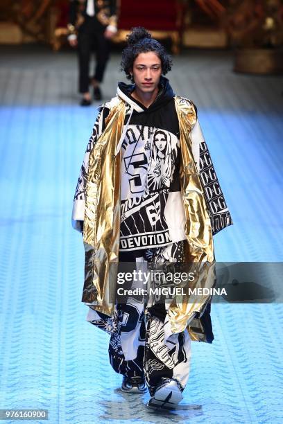 Model presents a creation by Dolce & Gabbana during the men's & women spring/summer 2019 collection fashion show in Milan, on June 16, 2018.