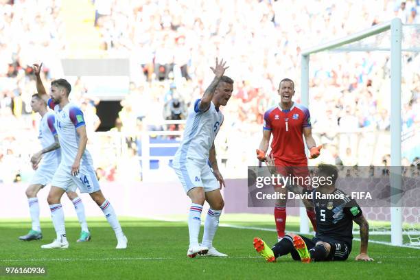 Lucas Biglia of Argentina argues after being tackled by Ragnar Sigurdsson of Iceland during the 2018 FIFA World Cup Russia group D match between...