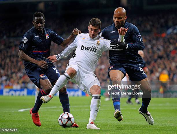 Gonzalo Higuain of Real Madrid competes for the ball with Jean-Alain Boumsong and Aly Cissokho of Olympique Lyonnais during the UEFA Champions League...