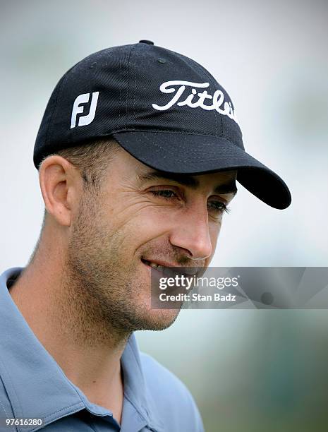 Geoff Ogilvy of Australia smiles on the practice range during practice for the World Golf Championships-CA Championship at Doral Golf Resort and Spa...