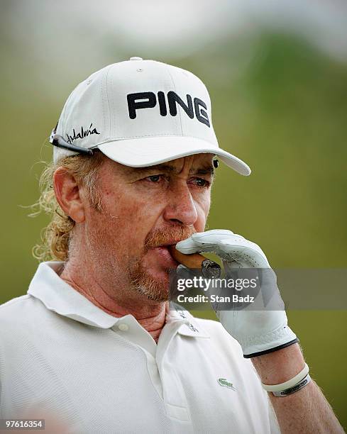 Miguel A. Jimenez of Spain watches from the practice range during practice for the World Golf Championships-CA Championship at Doral Golf Resort and...