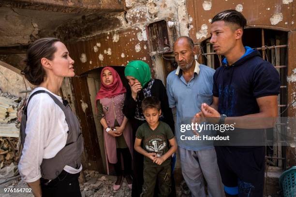 In this handout image provided by United Nations High Commission for Refugees, UNHCR Special Envoy Angelina Jolie meets with Mohamed and his family...