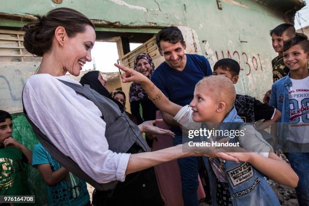 In this handout image provided by United Nations High Commission for Refugees, UNHCR Special Envoy Angelina Jolie meets Falak during a visit to West...