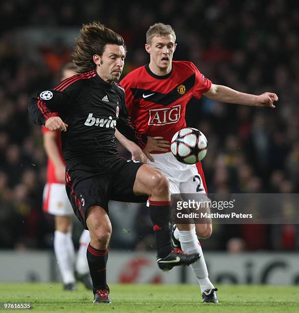 Darren Fletcher of Manchester United clashes with Andrea Pirlo of AC Milan during the UEFA Champions League First Knockout Round Second Leg match...