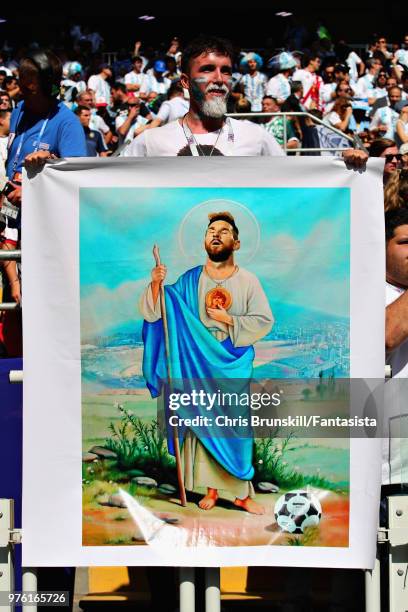 An Argentina fan holds a poster depicting Lionel Messi of Argentina before the 2018 FIFA World Cup Russia group D match between Argentina and Iceland...