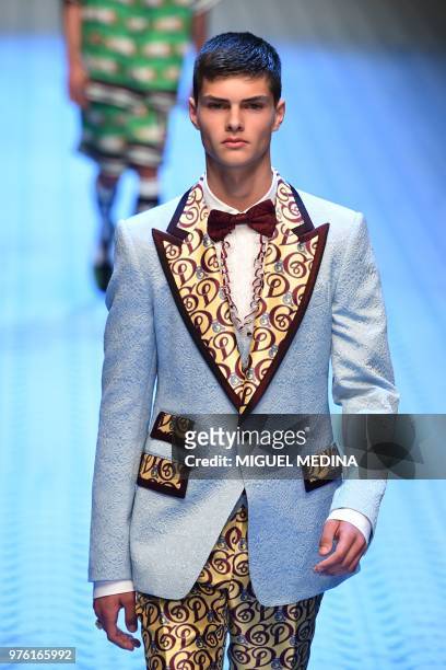 Model presents a creation by Dolce & Gabbana during the men & women's spring/summer 2019 collection fashion show in Milan, on June 16, 2018.