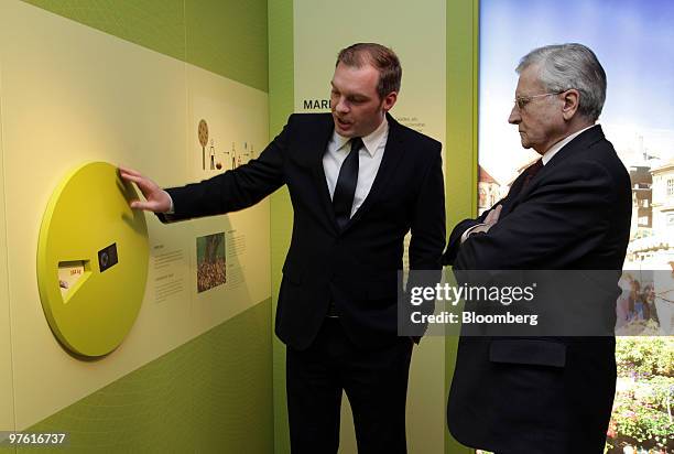 Gregor Isenbort, project manager at the Communication Museum, left, talks with Jean-Claude Trichet, president of the European Central Bank , during a...