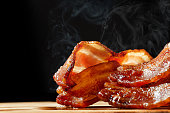 Hot Bacon With Steam Isolated on Black
