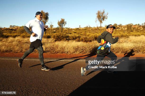 Australian Olympian Kyle Vander Kuyp runs with a junior runner as they take part in the Deadly Fun Run during the the National Deadly Fun Run...