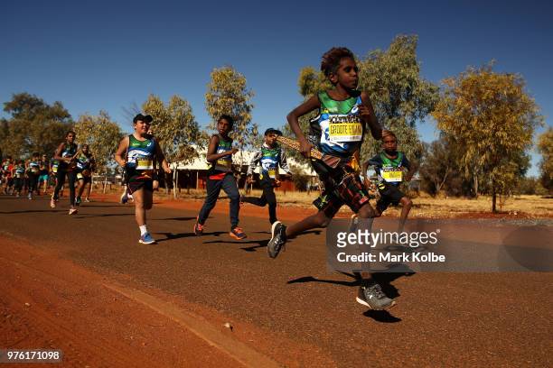 Competitors leave the Mutitjulu community as they run during the Uluru Relay Run as part of the National Deadly Fun Run Championships on June 16,...