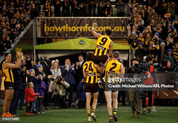 Shaun Burgoyne of the Hawks is chaired from the field after his 350th match by teammates Ben Stratton and Jarryd Roughead during the 2018 AFL round...