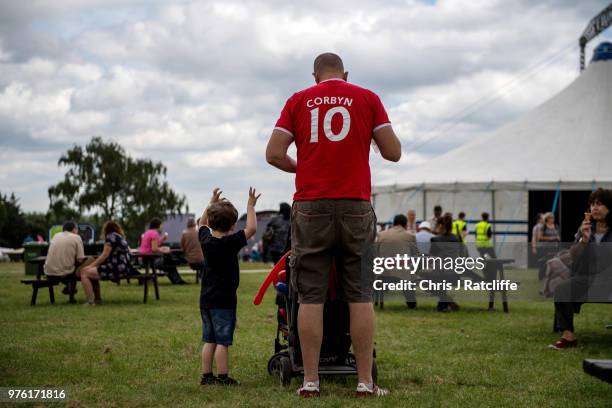 Festival attendee wears a t-shirt referencing Jeremy Corbyn with his children at Labour Live, White Hart Lane, Tottenham on June 16, 2018 in London,...