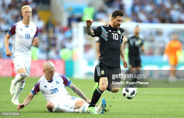 Emil Hallfredsson of Iceland tackles Lionel Messi of Argentina during the 2018 FIFA World Cup Russia group D match between Argentina and Iceland at...