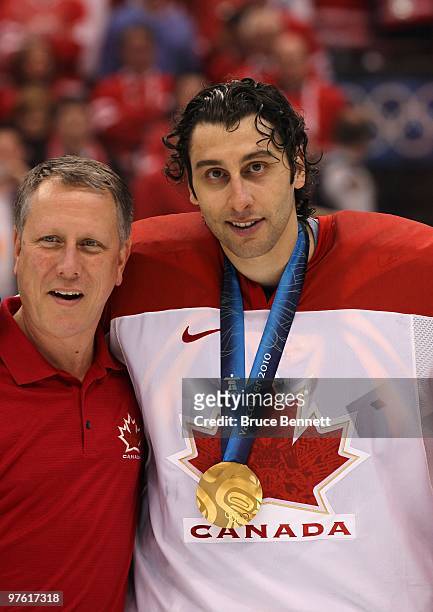Goaltender Roberto Luongo and a member of Canada pose for a photo after the ice hockey men's gold medal game between USA and Canada on day 17 of the...