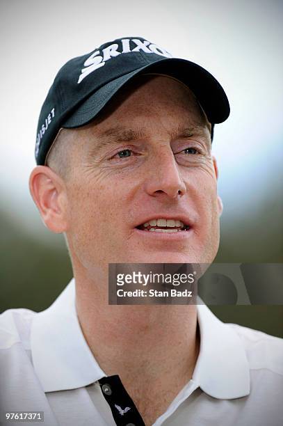 Jim Furyk smiles during an interview on the practice range during practice for the World Golf Championships-CA Championship at Doral Golf Resort and...