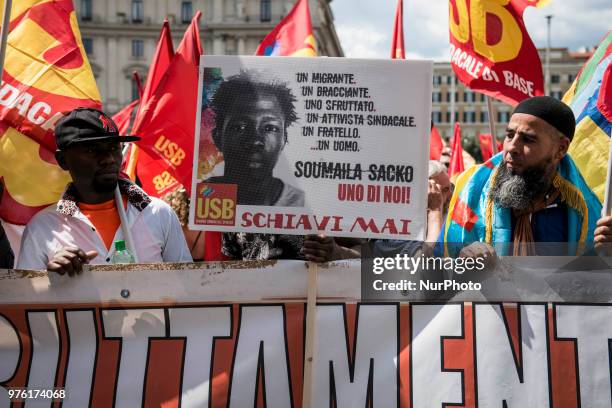Demonstrator holds up a photo of Soumaila Sacko during a march organized by Italy's USB against the murder of the USB syndicalist Sacko and the...