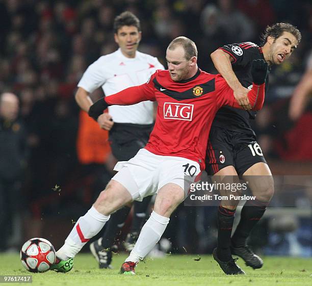 Wayne Rooney of Manchester United clashes with Mathieu Flamini of AC Milan during the UEFA Champions League First Knockout Round Second Leg match...