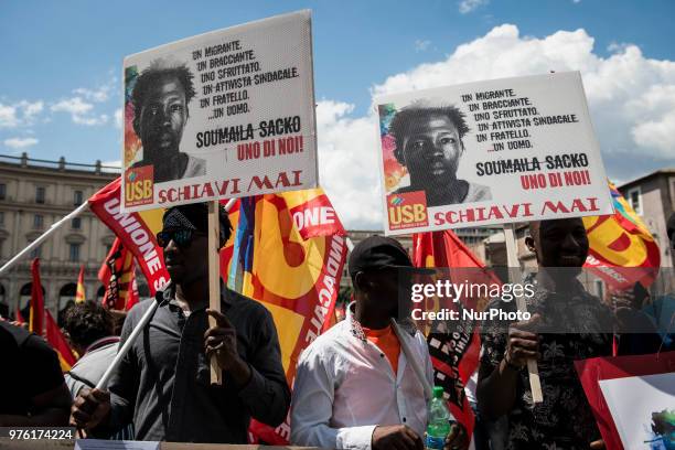 Demonstrators hold up a photo of Soumaila Sacko during a march organized by Italy's USB against the murder of the USB syndicalist Sacko and the...