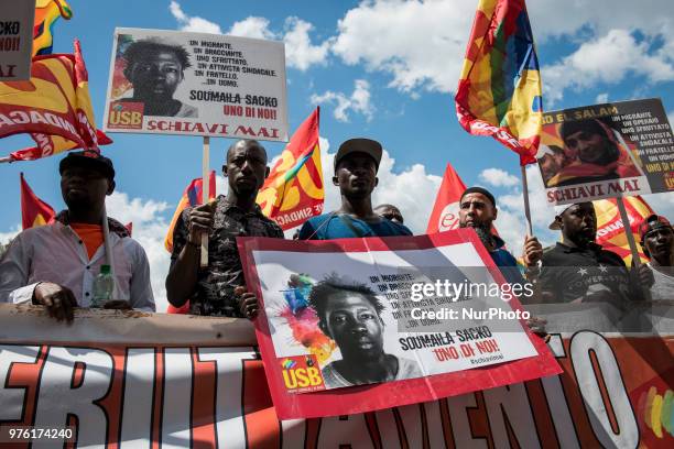 Demonstrators hold up a photo of Soumaila Sacko during a march organized by Italy's USB against the murder of the USB syndicalist Sacko and the...