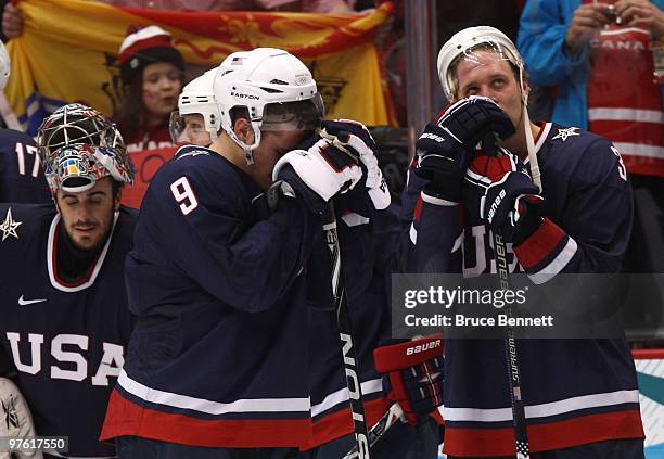 Goaltender Ryan Miller, Zach Parise and Jack Johnson of USA look on dejected after losing their match in the ice hockey men's gold medal game between...