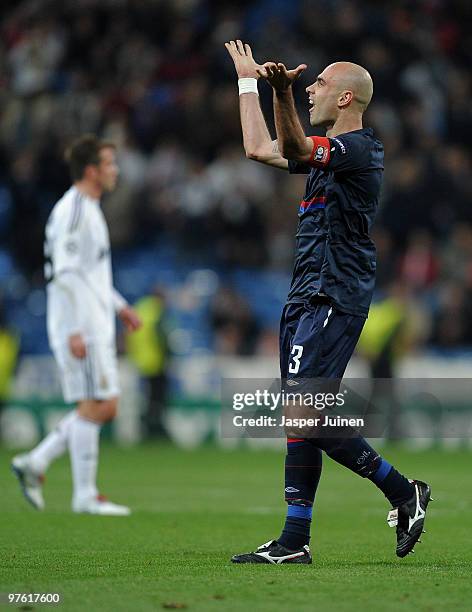 Captain Cris of Lyon celebrates backdropped by Rafael van der Vaart of Real Madrid at the end of the UEFA Champions League round of 16 second leg...