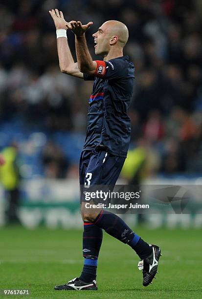 Cris captain of Lyon celebrates at the end of the UEFA Champions League round of 16 second leg match between Real Madrid and Lyon at the Estadio...