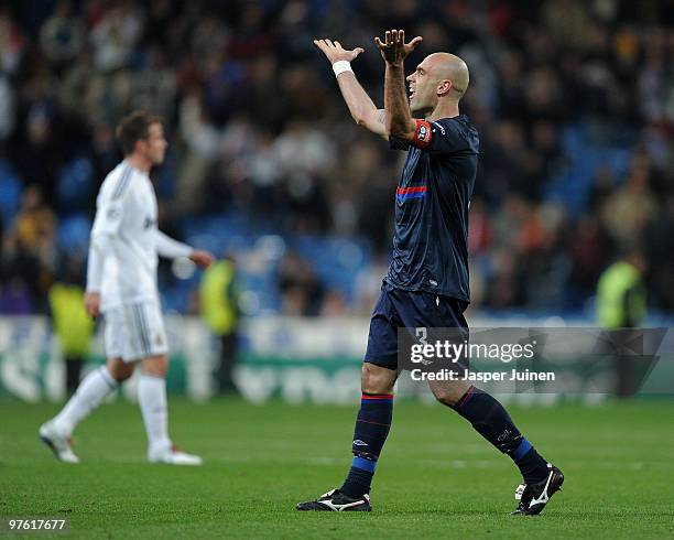 Captain Cris of Lyon celebrates backdropped by Rafael van der Vaart of Real Madrid at the end of the UEFA Champions League round of 16 second leg...