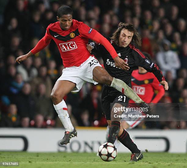 Antonio Valencia of Manchester United clashes with Andrea Pirlo of AC Milan in action during the UEFA Champions League First Knockout Round Second...