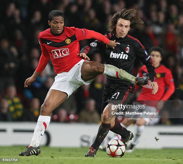 Antonio Valencia of Manchester United clashes with Andrea Pirlo of AC Milan in action during the UEFA Champions League First Knockout Round Second...