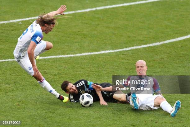 Birkir Bjarnason and Emil Hallfredsson of Iceland clash with Lionel Messi of Argentina during the 2018 FIFA World Cup Russia group D match between...