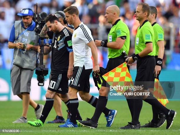 Argentina's forward Lionel Messi walks off the pitch with Argentina's defender Cristian Ansaldi at the end of the Russia 2018 World Cup Group D...