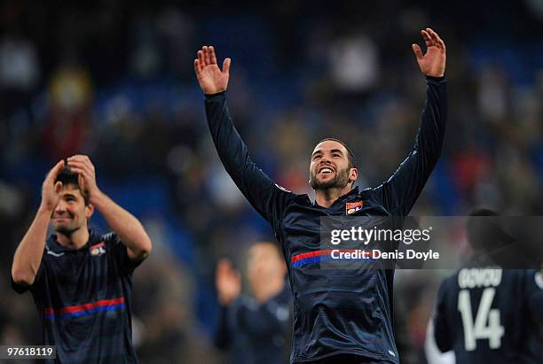 Lisandro and Jeremy Toulalan of Olympique Lyonnais celebrate victory after the UEFA Champions League round of 16 2nd leg match between Real Madrid...