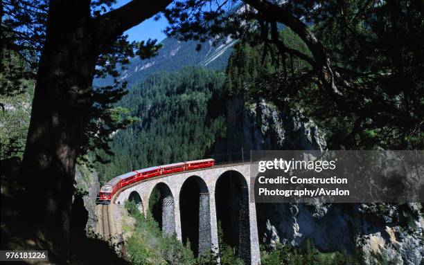 Local train of Rhaetian railway crossing landwasser viaduct - Swiss Alps - canton of Grisons - Switzerland.