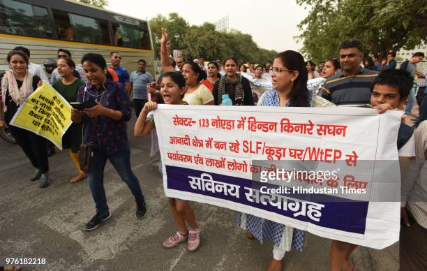 Residents and villagers during a protest march against dumping ground at sector 123, on June 16, 2018 in Noida, India. The National Green Tribunal...