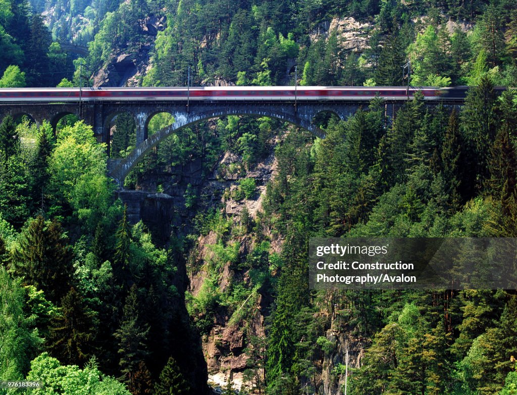 Intercity train on Saint Gotthard railway track - bridge (near the village of Wassen) - Swiss Alps - canton of Uri - Switzerland