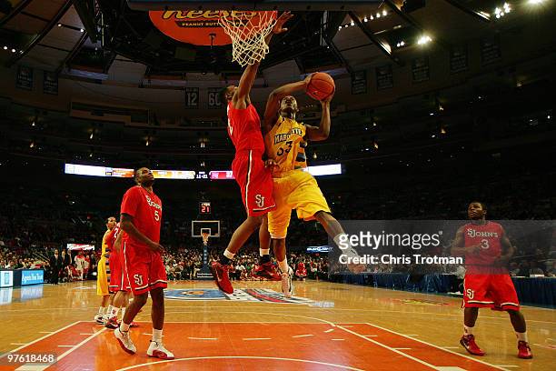 Jimmy Butler of the Marquette Golden Eagles goes to the hoop against Justin Brownlee of the St. John's Red Storm during the second round of 2010 NCAA...