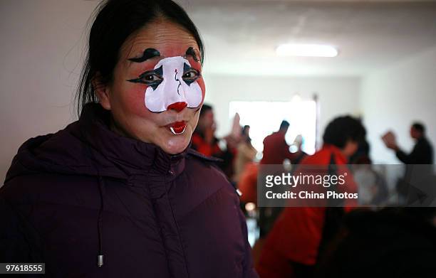 An actress of Gan Opera, who plays the role of Chou , prepares for performance at the Lusigang Township on February 19, 2010 in Yugan County of...